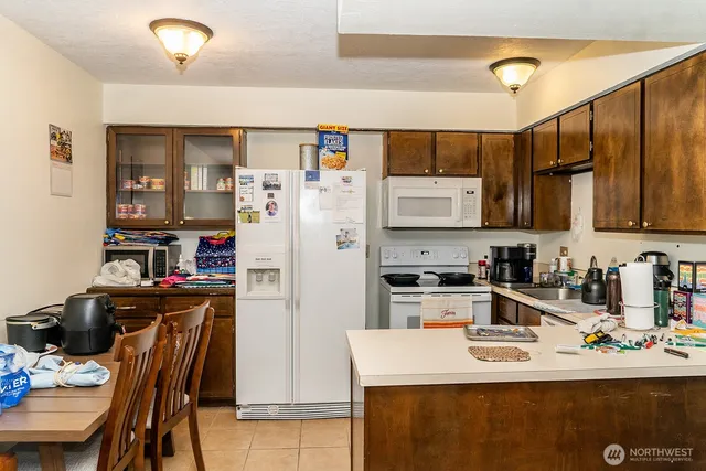 a kitchen with stainless steel appliances a refrigerator sink and cabinets