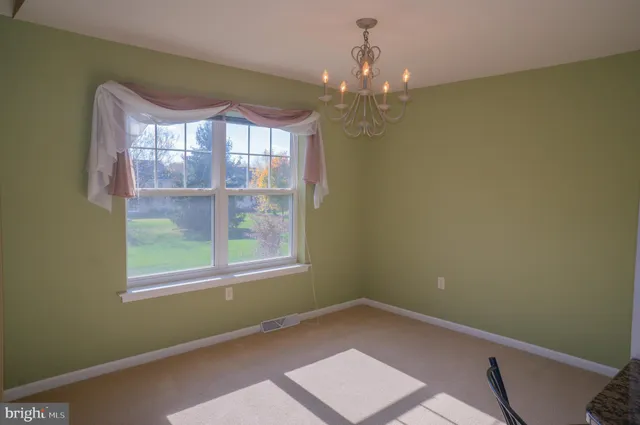 a view of a livingroom with furniture and chandelier