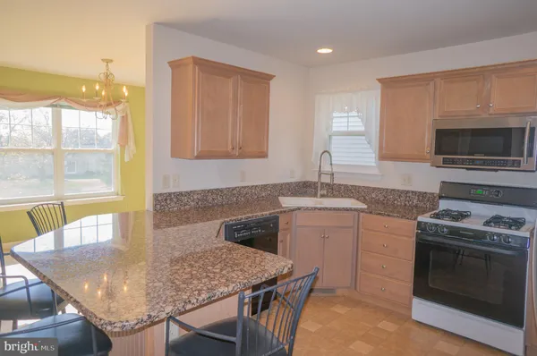 a kitchen with a granite countertop sink and a granite counter top