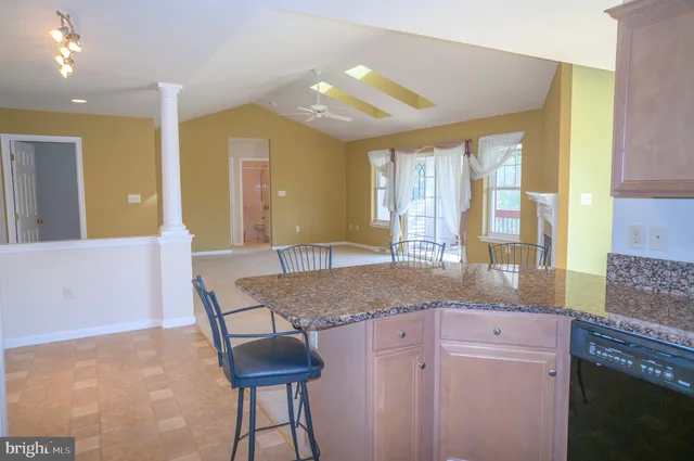 a kitchen with stainless steel appliances granite countertop a refrigerator stove and microwave