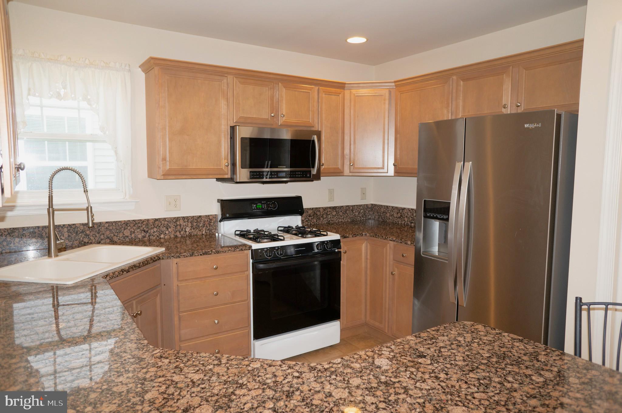 1221 Brighton Avenue Lititz, PA 17543 - Photo 10 of 57 a kitchen with stainless steel appliances granite countertop a refrigerator stove and microwave