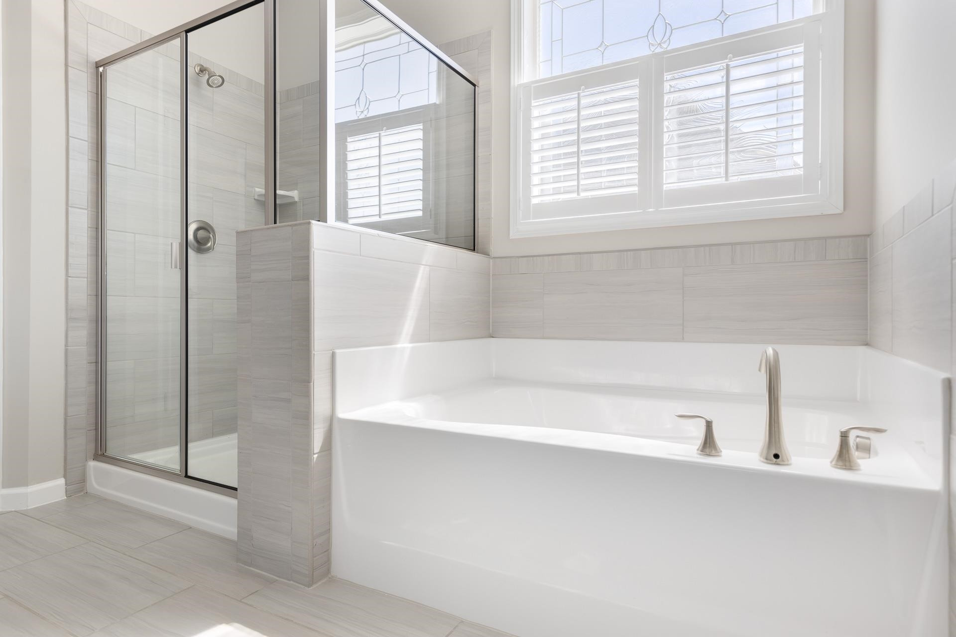 1010 Valley Rose Way Durham, NC 27712 - Photo 28 of 40 a bathroom with a bathtub and a shower