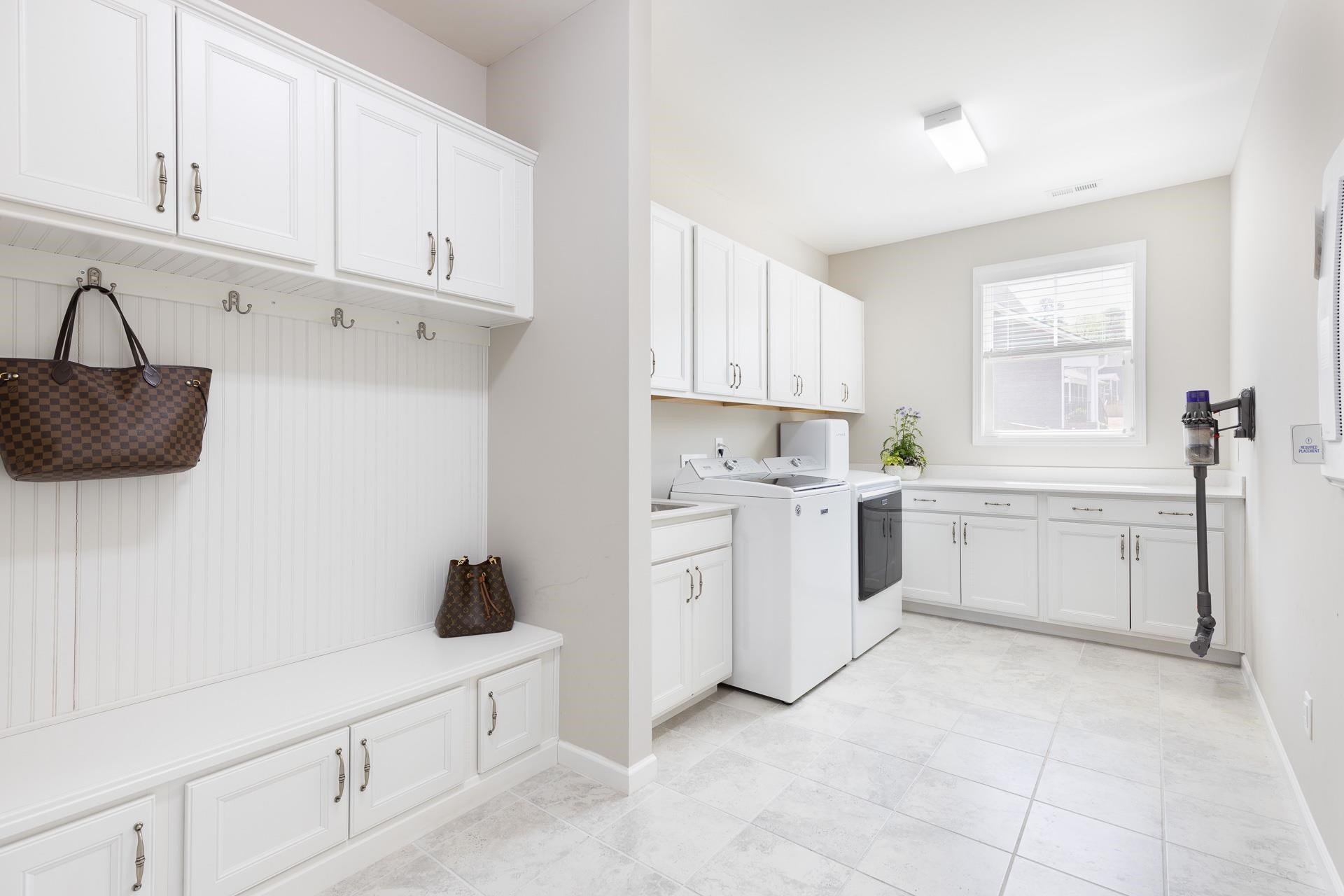 1010 Valley Rose Way Durham, NC 27712 - Photo 31 of 40 a kitchen with white cabinets and white appliances