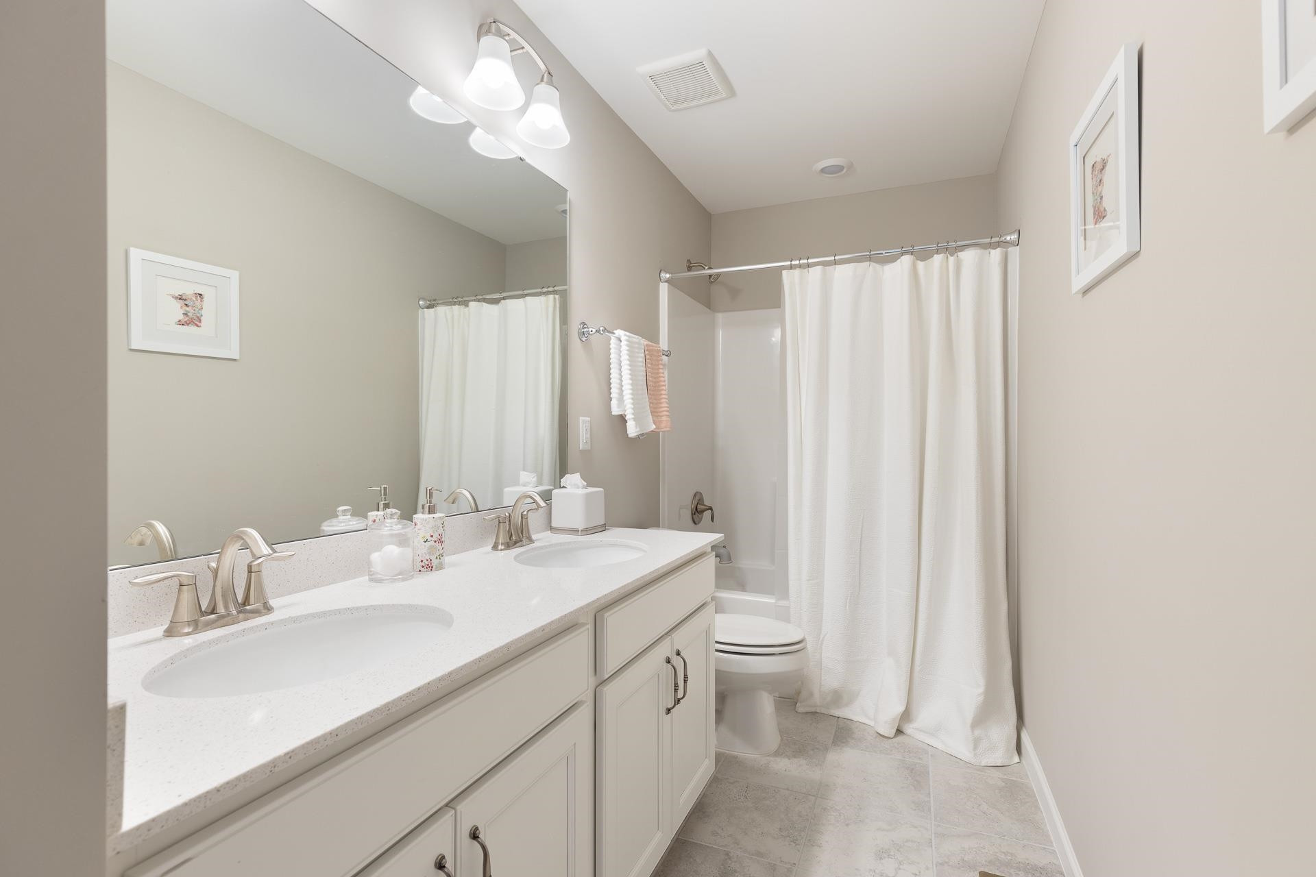 1010 Valley Rose Way Durham, NC 27712 - Photo 34 of 40 a bathroom with double vanity sink a toilet and a large mirror