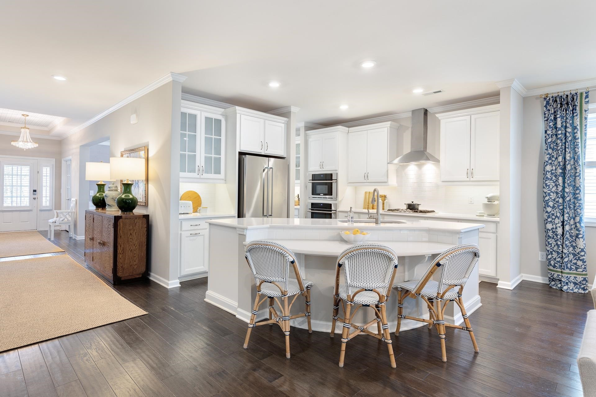 1010 Valley Rose Way Durham, NC 27712 - Photo 10 of 40 a kitchen with stainless steel appliances a dining table chairs refrigerator and sink