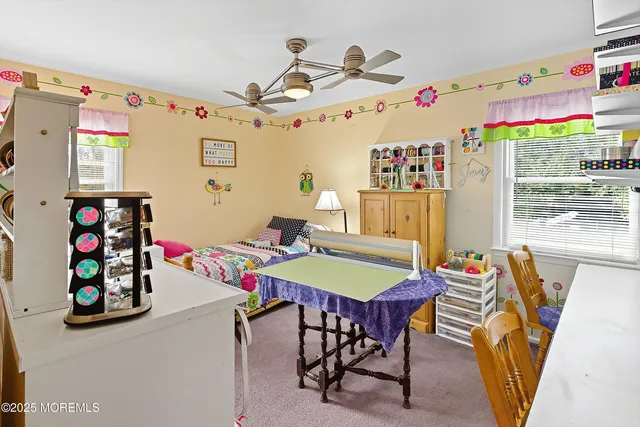 a view of a dining room with furniture and a window