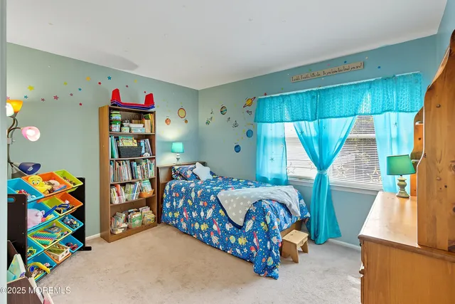 a bedroom with a bed and a wooden floor