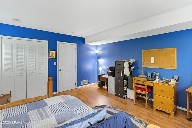 a view of a workspace with furniture and wooden floor