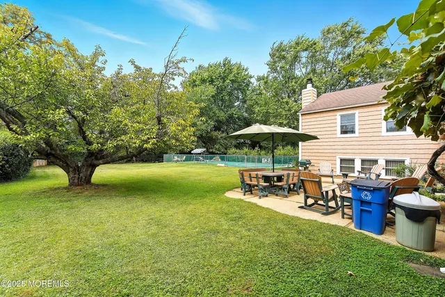 a view of a house with backyard and sitting area