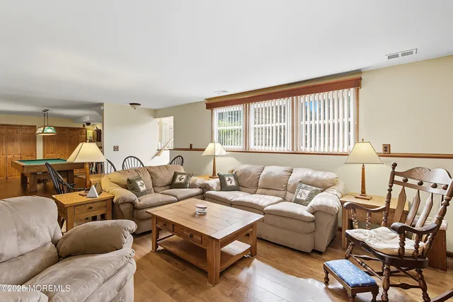 a living room with furniture a table and a large window