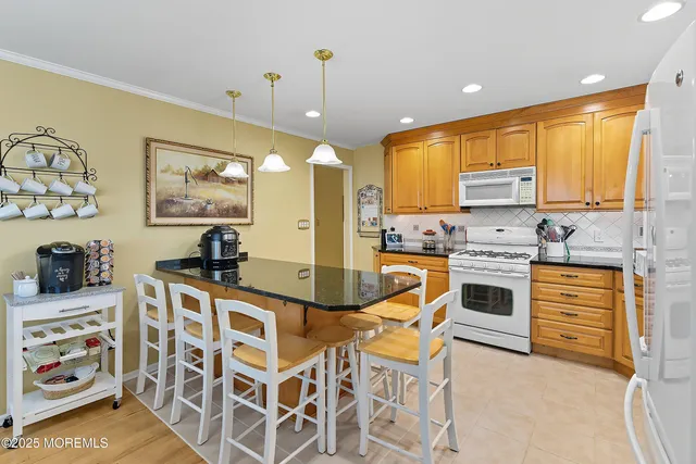 a kitchen with stainless steel appliances kitchen island granite countertop a sink and cabinets
