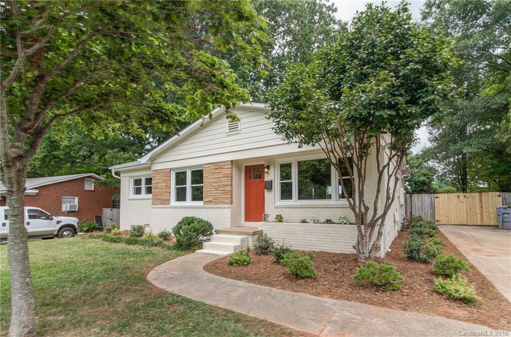 2431 Eaton Road Charlotte, NC 28205 - Photo 2 of 19 a front view of a house with a yard and potted plants