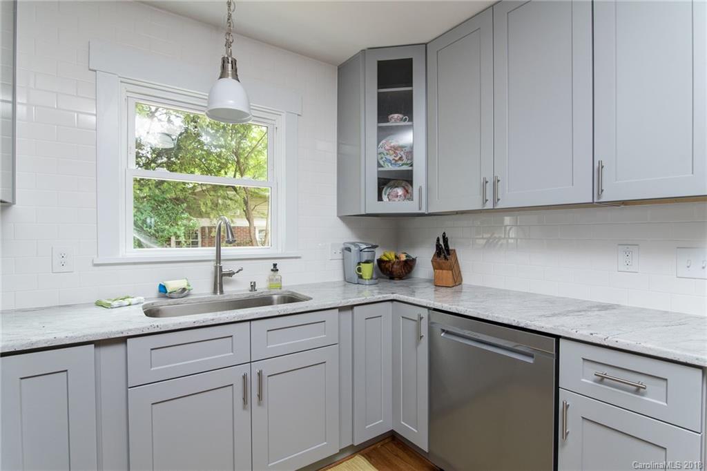 2431 Eaton Road Charlotte, NC 28205 - Photo 15 of 19 a kitchen with stainless steel appliances granite countertop white cabinets and a window