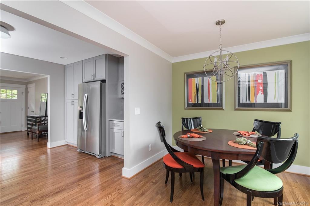 2431 Eaton Road Charlotte, NC 28205 - Photo 17 of 19 a view of a dining room with furniture wooden floor and chandelier