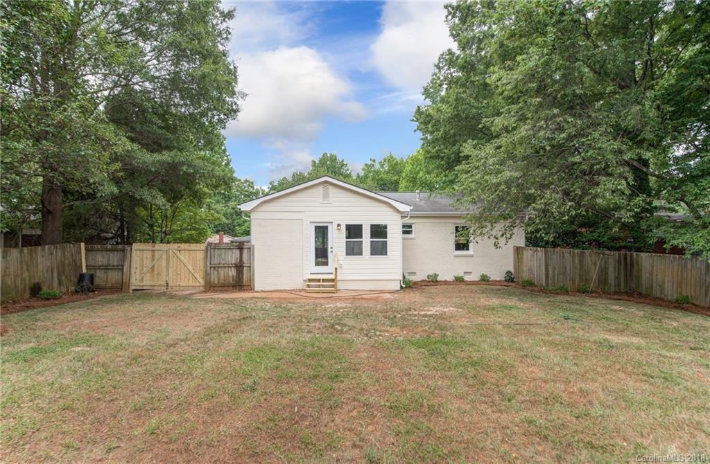2431 Eaton Road Charlotte, NC 28205 - Photo 18 of 19 a view of a house with a yard and fence
