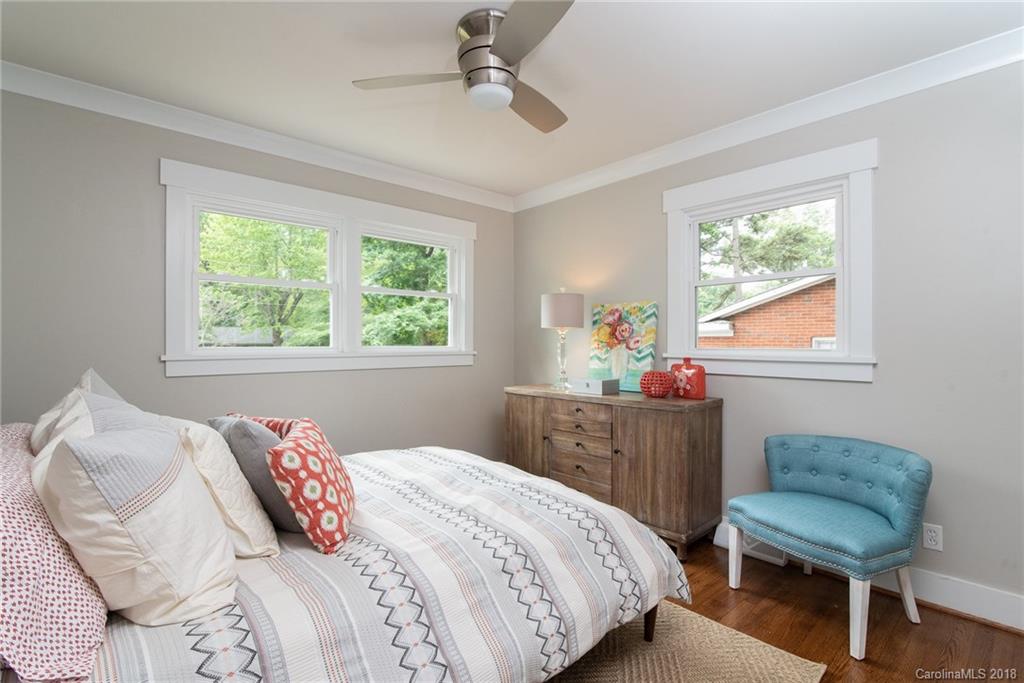 2431 Eaton Road Charlotte, NC 28205 - Photo 3 of 19 a bedroom with a bed window and a chair