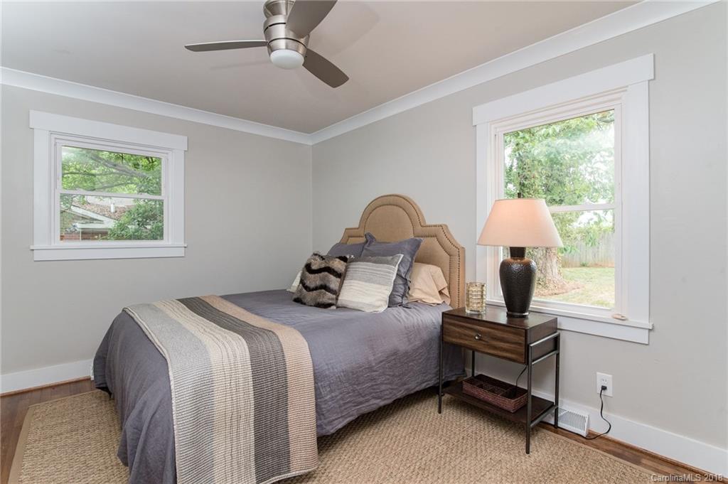 2431 Eaton Road Charlotte, NC 28205 - Photo 5 of 19 a bedroom with a bed and large windows