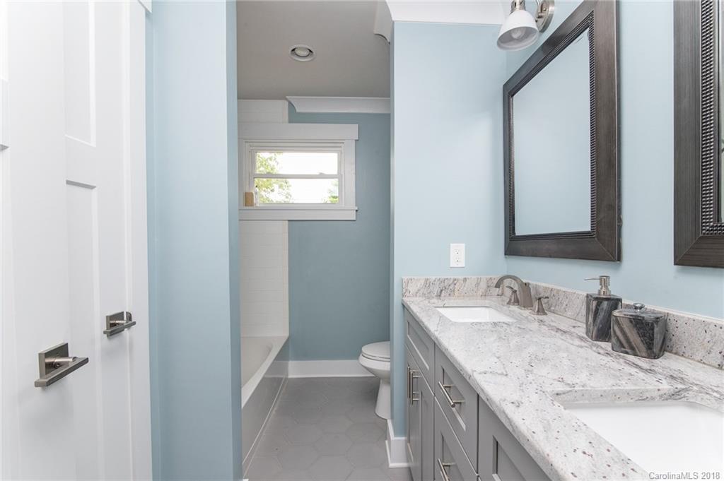 2431 Eaton Road Charlotte, NC 28205 - Photo 6 of 19 a bathroom with a granite countertop sink a toilet and a mirror