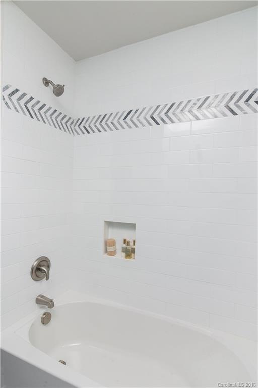 2431 Eaton Road Charlotte, NC 28205 - Photo 8 of 19 a bathroom with a bathtub and shower