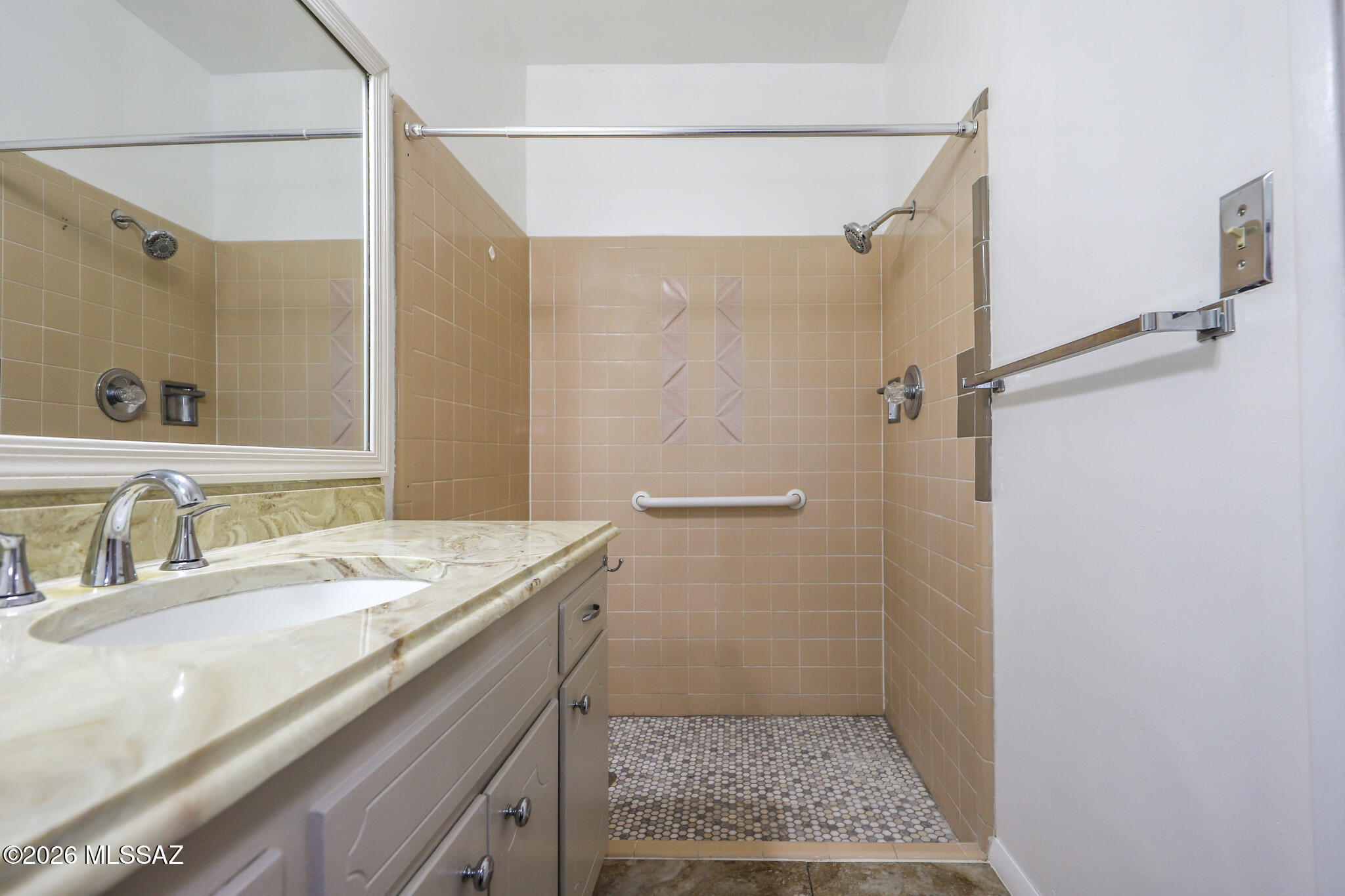 37 North Silverbell Road Tucson, AZ 85745 - Photo 19 of 31 a bathroom with a granite countertop sink a mirror and shower