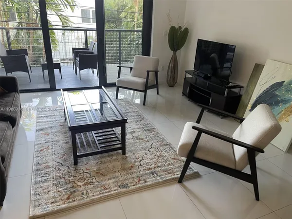 a living room with furniture a dining table and chairs