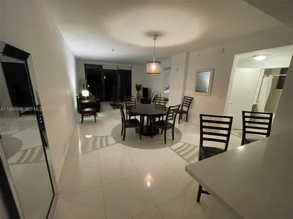 a bed sitting in a bedroom next to a cabinet