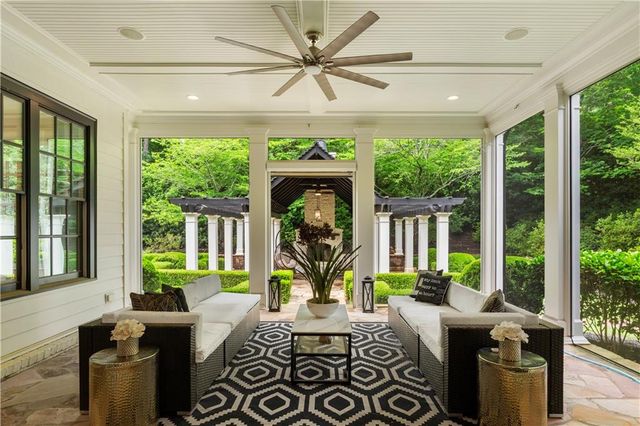 a open kitchen with kitchen island a stove a sink dishwasher and white cabinets with wooden floor