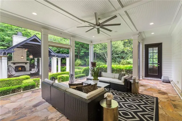 a living room with furniture a flat screen tv and a fireplace