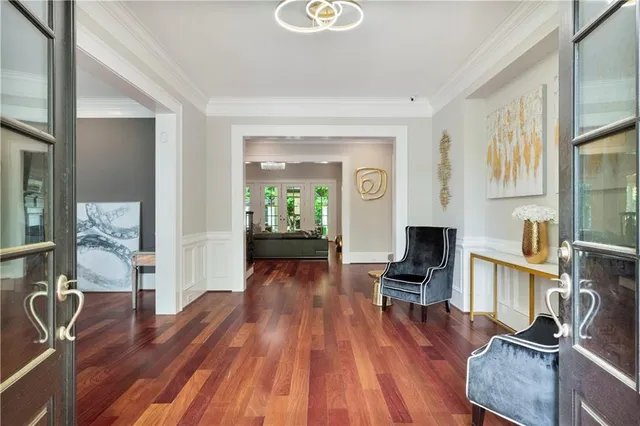 a spacious bedroom with a large bed a flat screen tv and a large window