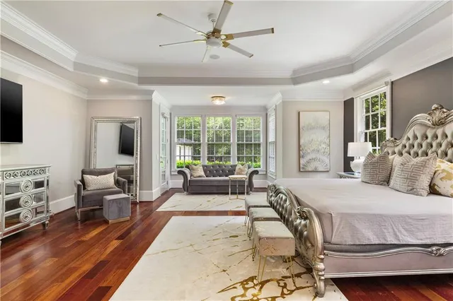 a spacious bedroom with a bed and a ceiling fan