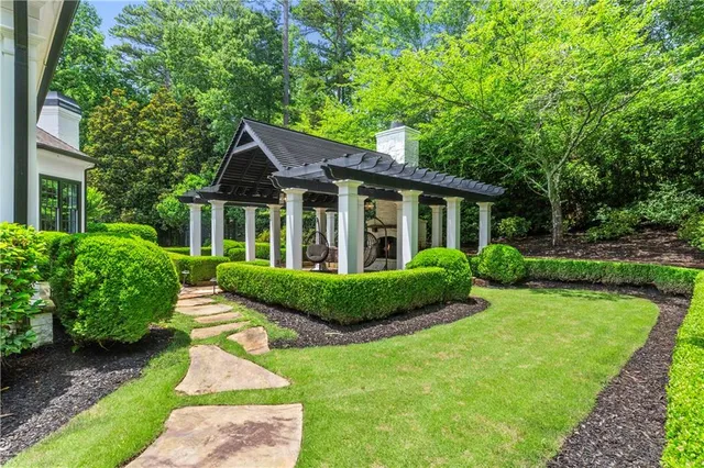 a kitchen with a stove and wooden floor