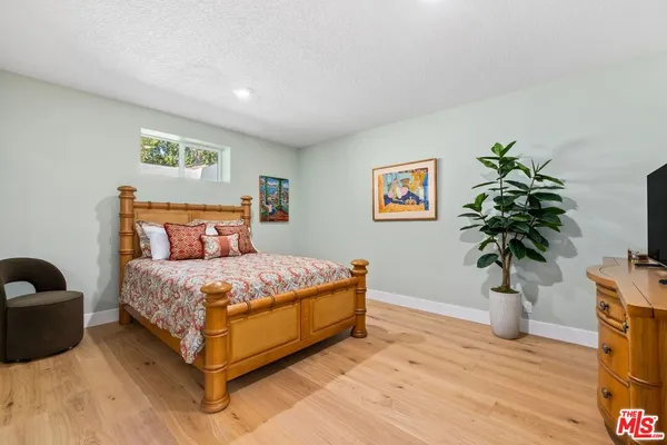 a bedroom with a bed and a potted plant