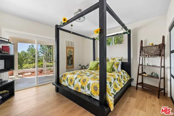 a bedroom with a bed and large window
