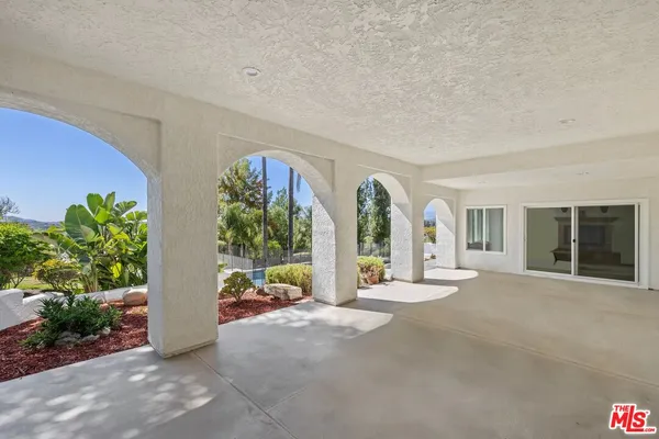 a view of a house with backyard and sitting area