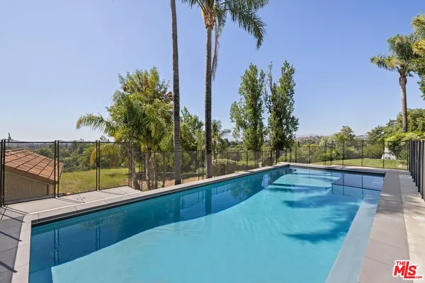 a view of a swimming pool with a patio