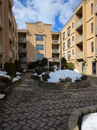 a view of a kitchen with wooden floor and a sink