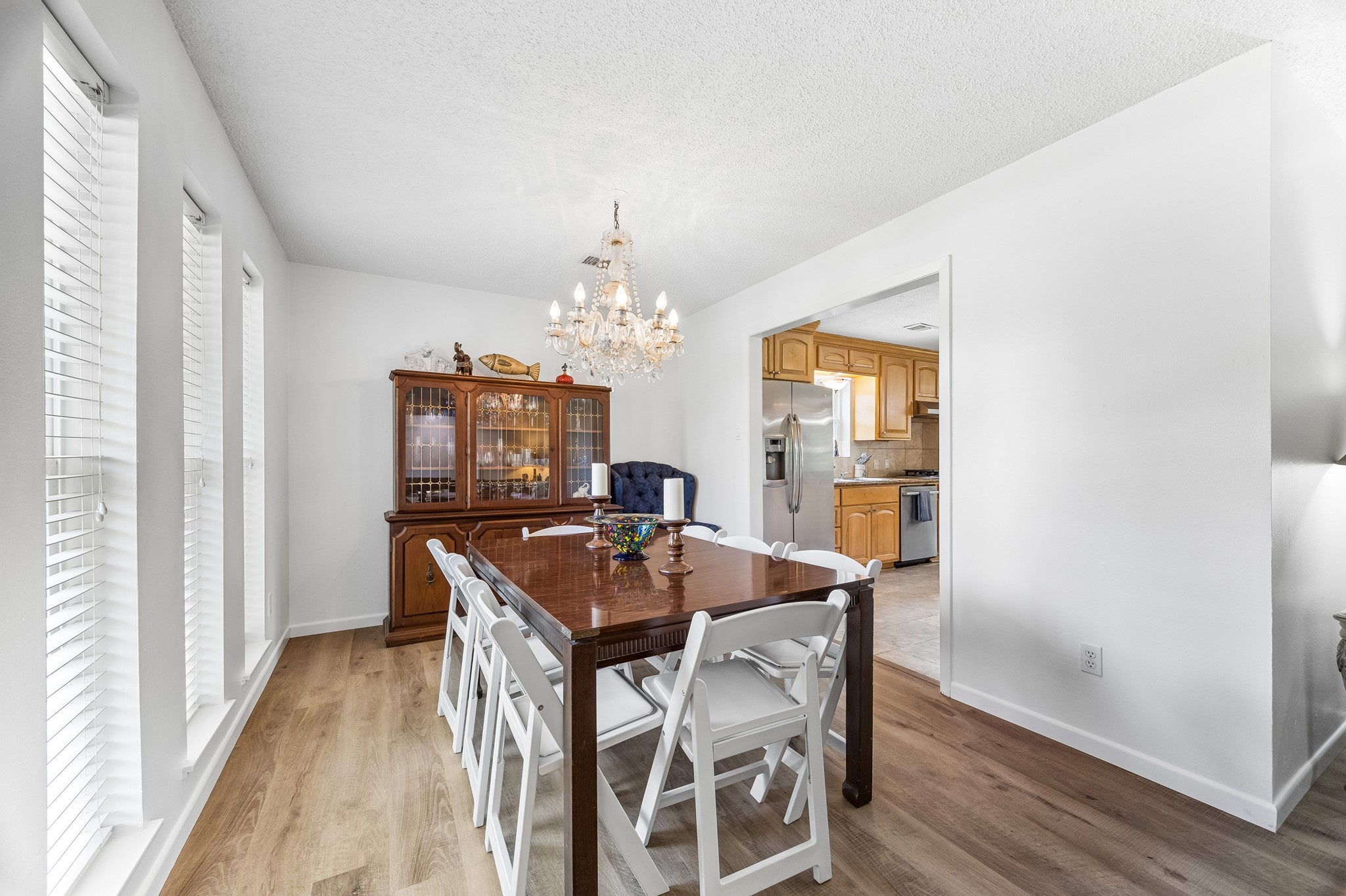 413 Mebane Lane Rosenberg, TX 77471 - Photo 13 of 30 This dining area features a chandelier, large windows for natural light, and has direct access to the kitchen. Fresh paint and updated flooring makes this the ideal place to gather with family and friends.
