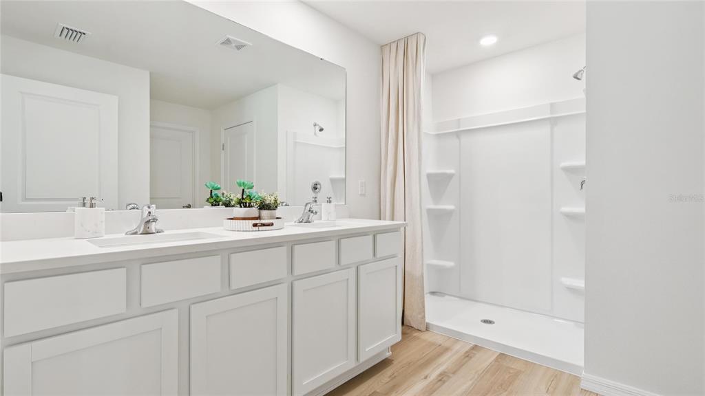 10092 Bedford Road Spring Hill, FL 34608 - Photo 14 of 21 a bathroom with a shower sink and mirror