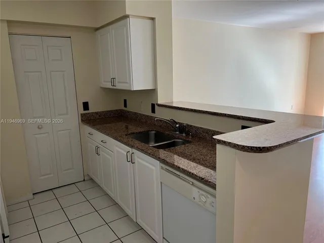 a kitchen with granite countertop cabinets and sink