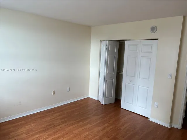 an empty room with wooden floor