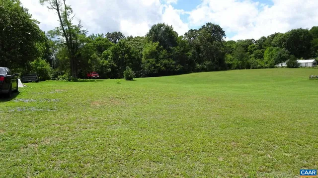 a view of a field of grass and trees
