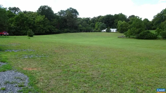 a view of field with trees in the background
