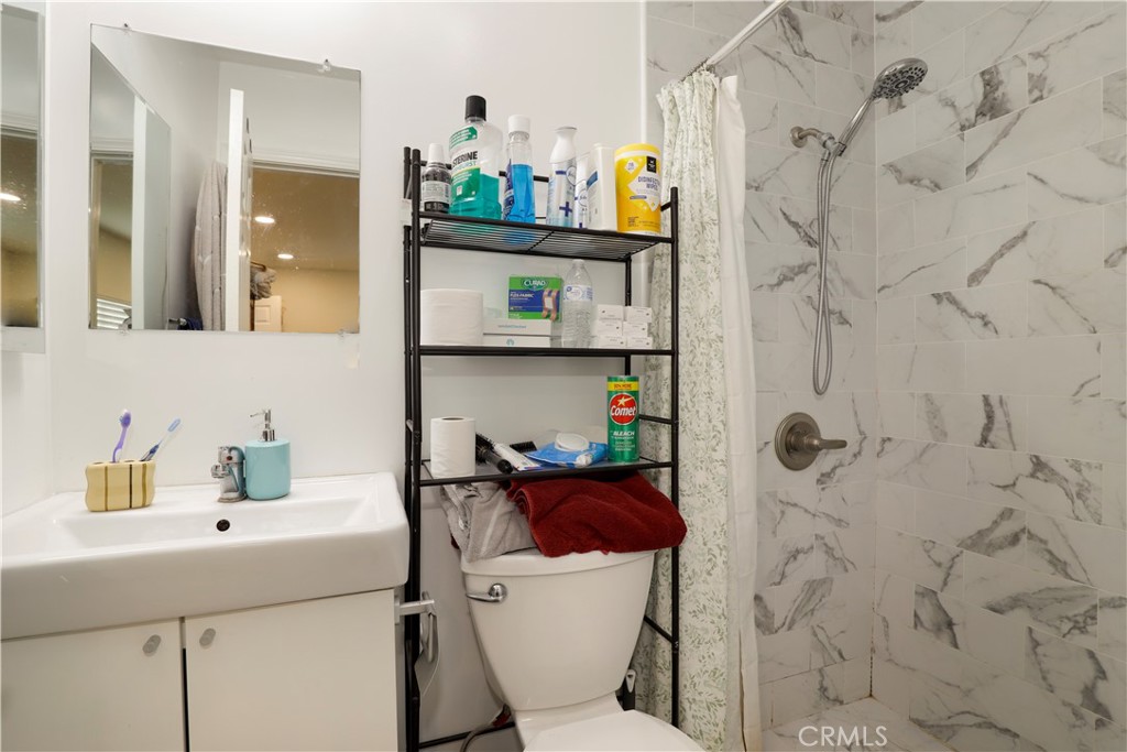 15040 Root Street Baldwin Park, CA 91706 - Photo 16 of 23 a bathroom with a sink mirror vanity and toilet
