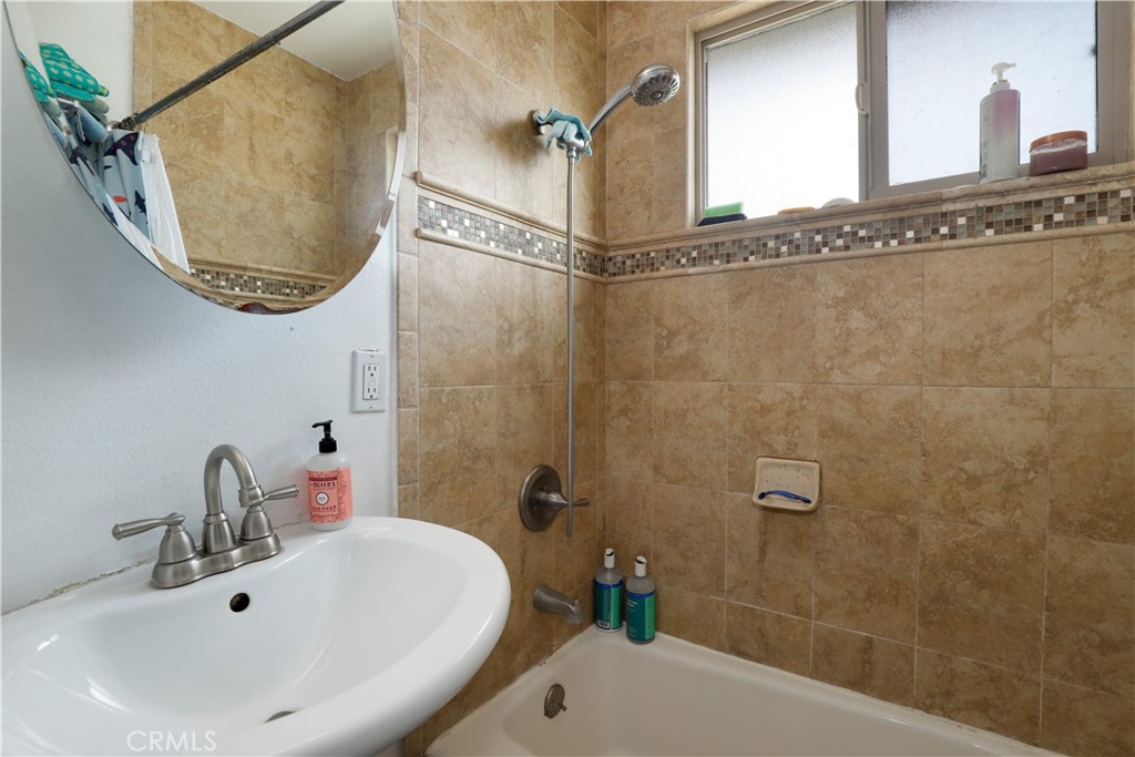 15040 Root Street Baldwin Park, CA 91706 - Photo 17 of 23 a bathroom with a sink and mirror with bathtub