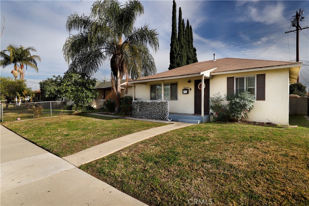 15040 Root Street Baldwin Park, CA 91706 - Photo 2 of 23 a view of a white house with a yard and palm trees