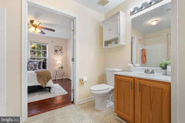 a bathroom with a sink toilet and mirror