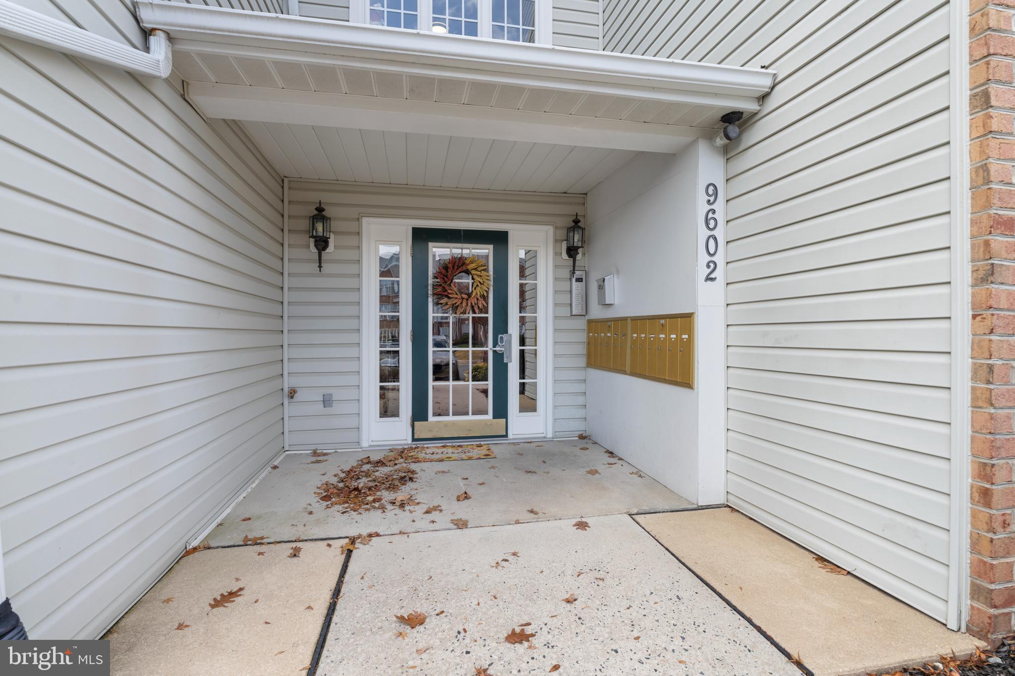 9602 Haven Farm Road, Unit 9602B Perry Hall, MD 21128 - Photo 2 of 37 a view of a house with a door and wooden bench