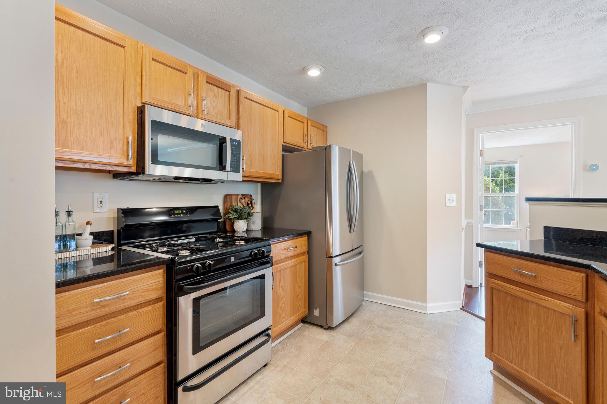9602 Haven Farm Road, Unit 9602B Perry Hall, MD 21128 - Photo 24 of 37 a kitchen with stainless steel appliances a refrigerator stove and microwave