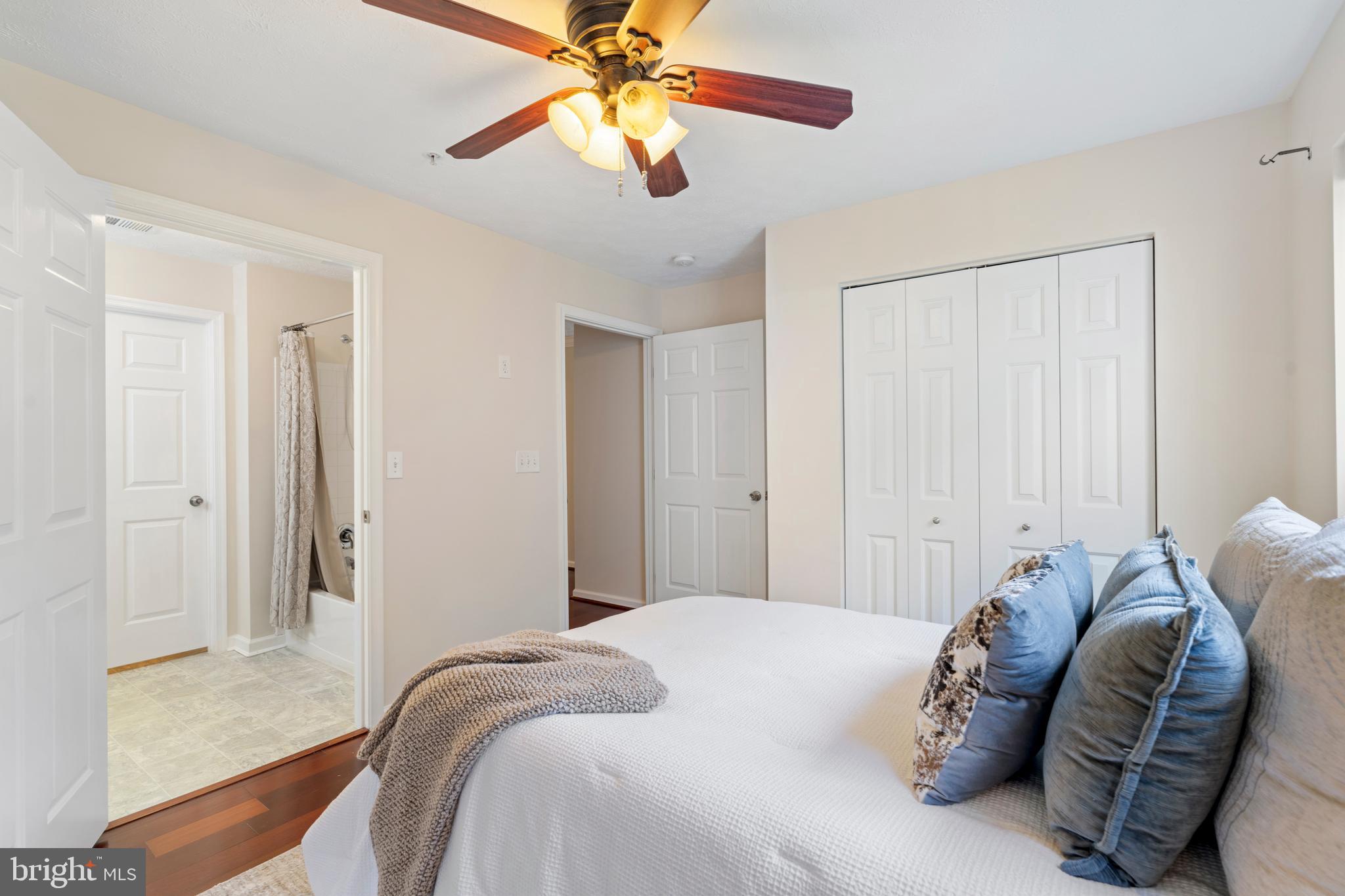 9602 Haven Farm Road, Unit 9602B Perry Hall, MD 21128 - Photo 29 of 37 a bedroom with a bed and a chandelier