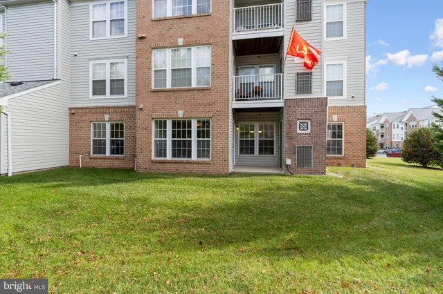 a view of house with backyard and deck